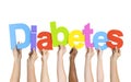 Multi-Ethnic Hands Holding The Word Diabetes Royalty Free Stock Photo