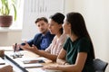 Businesspeople listening african ethnicity team leader at group meeting