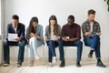 Multi-ethnic millennial people wait in queue preparing for job i