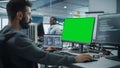 Multi-Ethnic Office: White IT Programmer Working on Computer with Green Screen Chroma Key Display Royalty Free Stock Photo