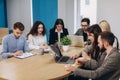 Multi ethnic people entrepreneur, small business concept. Woman showing coworkers something on laptop computer as they gather