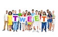 Multi-Ethnic People Holding The Word Tweet Royalty Free Stock Photo