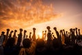 Multi-ethnic people raise their fists up in the air. autumn sunset background