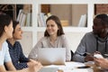 Multi-ethnic students sitting at classroom desk study together