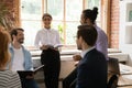 Multi ethnic teammates discussing common project at briefing in office Royalty Free Stock Photo