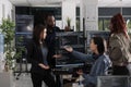 Multi ethnic web developers writing script while talking Royalty Free Stock Photo