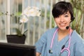 Multi-ethnic Woman Wearing Headset and Stethoscope Royalty Free Stock Photo