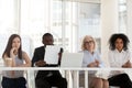 Multi-ethnic workers of recruiting agency interviewing applicant