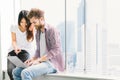 Multi-ethnic young couple or college student using notebook laptop together in campus or office. Information technology concept Royalty Free Stock Photo