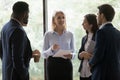 Multiethnic young employees listen guidance of middle-aged female boss Royalty Free Stock Photo