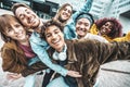 Multi ethnic young people smiling together at camera outside Royalty Free Stock Photo