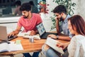 Multi ethnic young students preparing for exams in home interior Royalty Free Stock Photo