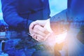 Multi exposure of Businesspeople shaking hands of business partner as commitment regarding shipping freight and industry logistics