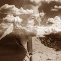 Multi exposure portrait of a thinking man with clouds on the background