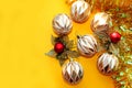 Multi-faceted Christmas balls with decorations on a bright yellow background. Royalty Free Stock Photo