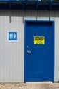A multi-gender bathroom with a do not leave children unattended warning Royalty Free Stock Photo