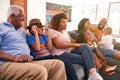 Multi-Generation African American Family Relaxing At Home Sitting On Sofa Watching TV Together Royalty Free Stock Photo