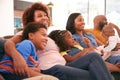 Multi-Generation African American Family Relaxing At Home Sitting On Sofa Watching TV Together Royalty Free Stock Photo