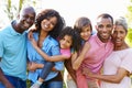 Multi Generation African American Family Standing In Garden