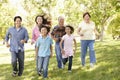 Multi-generation Asian family running in park Royalty Free Stock Photo