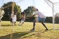 Multi generation black family playing football in a garden Royalty Free Stock Photo