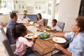 Multi generation black family serving a meal in the kitchen Royalty Free Stock Photo