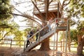 Multi-Generation Family Climbing Outdoor Wooden Platform To Tree House In Garden Royalty Free Stock Photo