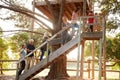 Multi-Generation Family Climbing Outdoor Wooden Platform To Tree House In Garden Royalty Free Stock Photo