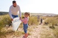 Multi-Generation Family Collecting Litter On Winter Beach Clean Up Royalty Free Stock Photo