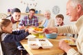 Multi Generation Family Eating Lunch At Kitchen Table Royalty Free Stock Photo