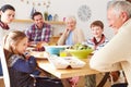 Multi Generation Family Eating Lunch At Kitchen Table Royalty Free Stock Photo