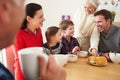 Multi Generation Family Eating Lunch At Kitchen Table Royalty Free Stock Photo