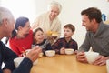 Multi Generation Family Eating Lunch At Kitchen Table Royalty Free Stock Photo