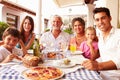 Multi Generation Family Eating Meal At Outdoor Restaurant Royalty Free Stock Photo