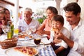 Multi Generation Family Eating Meal At Outdoor Restaurant Royalty Free Stock Photo