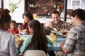 Multi Generation Family Enjoying Meal Around Table At Home Together Royalty Free Stock Photo