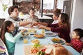 Multi Generation Family Enjoying Meal Around Table At Home Together Royalty Free Stock Photo