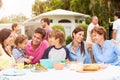 Multi Generation Family Enjoying Meal In Garden Together Royalty Free Stock Photo