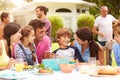 Multi Generation Family Enjoying Meal In Garden Together Royalty Free Stock Photo