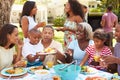 Multi Generation Family Enjoying Meal In Garden Together Royalty Free Stock Photo