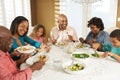 Multi Generation Family Enjoying Meal At Home Royalty Free Stock Photo