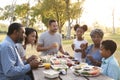 Multi Generation Family Enjoying Picnic In Park Together Royalty Free Stock Photo