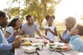 Multi Generation Family Enjoying Picnic In Park Together Royalty Free Stock Photo