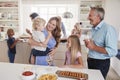 Multi-Generation Family And Friends Gathering In Kitchen For Celebration Party Royalty Free Stock Photo