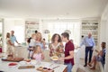 Multi-Generation Family And Friends Gathering In Kitchen For Celebration Party Royalty Free Stock Photo