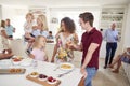 Multi-Generation Family And Friends Gathering In Kitchen For Celebration Party Royalty Free Stock Photo