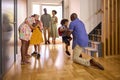 Multi-Generation Family With Grandparents Greeting Grandchildren in Hallway At Home Royalty Free Stock Photo