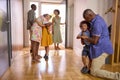 Multi-Generation Family With Grandparents Greeting Grandchildren in Hallway At Home Royalty Free Stock Photo