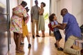 Multi-Generation Family With Grandparents Greeting Grandchildren in Hallway At Home Royalty Free Stock Photo