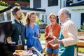 Multi generation family grilling outside on backyard in summer during garden party Royalty Free Stock Photo